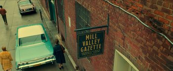 Movie still from “Scary Stories to Tell in the Dark” (2019), directed by André Øvredal – A sign hanging on the side of a brick building; Extreme Wide shot, High angle