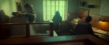 Movie still from “Scary Stories to Tell in the Dark” (2019), directed by André Øvredal – Two people sitting at a table in front of a window; Wide shot, Over the shoulder angle