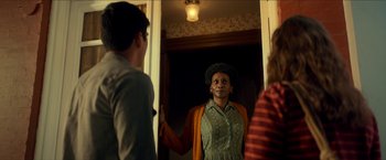 Movie still from “Scary Stories to Tell in the Dark” (2019), directed by André Øvredal – A man standing in front of two other people; Medium shot, Over the shoulder angle