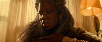 Movie still from “Scary Stories to Tell in the Dark” (2019), directed by André Øvredal – An older woman with long gray hair looking down at her face; Close Up shot, Over the shoulder angle