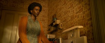 Movie still from “Scary Stories to Tell in the Dark” (2019), directed by André Øvredal – A woman standing in a kitchen next to a stove; Medium shot, Over the shoulder angle