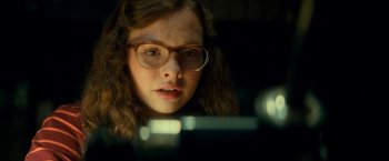 Movie still from “Scary Stories to Tell in the Dark” (2019), directed by André Øvredal – A woman with glasses looking at a camera; Close Up shot, Over the shoulder angle