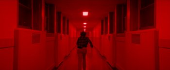 Movie still from “Scary Stories to Tell in the Dark” (2019), directed by André Øvredal – A person walking down a long red hallway; Wide shot, Low angle