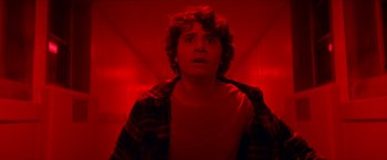 Movie still from “Scary Stories to Tell in the Dark” (2019), directed by André Øvredal – A young man with a surprised look on his face; Close Up shot, Low angle