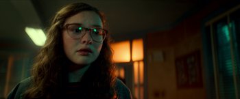 Movie still from “Scary Stories to Tell in the Dark” (2019), directed by André Øvredal – A woman with glasses is looking at the camera; Close Up shot, Over the shoulder angle