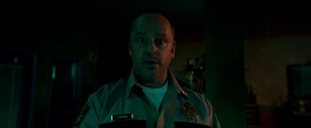 Movie still from “Scary Stories to Tell in the Dark” (2019), directed by André Øvredal – A person wearing a police uniform; Close Up shot, Low angle