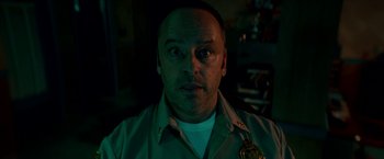Movie still from “Scary Stories to Tell in the Dark” (2019), directed by André Øvredal – A person wearing a police officer uniform; Close Up shot, Low angle