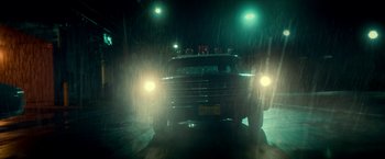 Movie still from “Scary Stories to Tell in the Dark” (2019), directed by André Øvredal – A truck driving down a street at night in the rain; Wide shot, Low angle