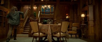 Movie still from “Scary Stories to Tell in the Dark” (2019), directed by André Øvredal – A dining room table set for a meal; Wide shot, High angle