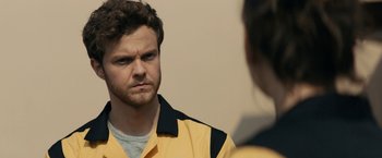 Movie still from “Scream” (2022), directed by Matt Bettinelli-Olpin – A man in a yellow and black jacket looking at a woman in a yellow and black jacket; Close Up shot, Over the shoulder angle