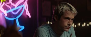 Movie still from “Scream” (2022), directed by Matt Bettinelli-Olpin – A man sitting in front of a window at night; Close Up shot, Low angle