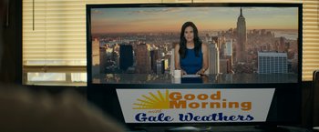 Movie still from “Scream” (2022), directed by Matt Bettinelli-Olpin – A woman sitting in front of a tv in front of a window; Medium shot, Low angle