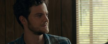 Movie still from “Scream” (2022), directed by Matt Bettinelli-Olpin – A person wearing a plaid shirt; Close Up shot, Over the shoulder angle