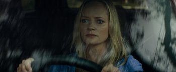 Movie still from “Scream” (2022), directed by Matt Bettinelli-Olpin – A woman sitting in the driver's seat of a car; Close Up shot, Over the shoulder angle