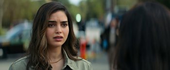 Movie still from “Scream” (2022), directed by Matt Bettinelli-Olpin – A person wearing a jacket on a city street; Close Up shot, Over the shoulder angle