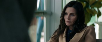 Movie still from “Scream” (2022), directed by Matt Bettinelli-Olpin – A person sitting in a room; Close Up shot, Over the shoulder angle