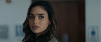 Movie still from “Scream” (2022), directed by Matt Bettinelli-Olpin – A person with long brown hair; Close Up shot, Over the shoulder angle