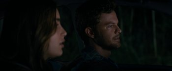 Movie still from “Scream” (2022), directed by Matt Bettinelli-Olpin – A man and a woman sitting in the back of a car; Close Up shot, Over the shoulder angle