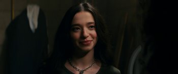 Movie still from “Scream” (2022), directed by Matt Bettinelli-Olpin – A woman with long black hair wearing a silver necklace; Close Up shot, Over the shoulder angle