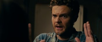 Movie still from “Scream” (2022), directed by Matt Bettinelli-Olpin – A person with a beard; Close Up shot, Over the shoulder angle