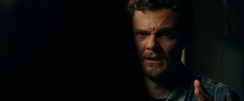 Movie still from “Scream” (2022), directed by Matt Bettinelli-Olpin – A person in a dark room; Close Up shot, Over the shoulder angle