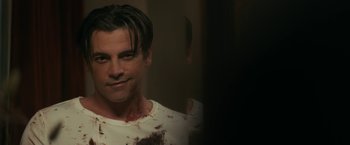Movie still from “Scream” (2022), directed by Matt Bettinelli-Olpin – A person with blood all over his face; Close Up shot, Over the shoulder angle