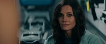 Movie still from “Scream” (2022), directed by Matt Bettinelli-Olpin – A person sitting in a room; Close Up shot, Over the shoulder angle