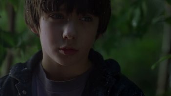 Movie still from “Searching for Bobby Fischer” (1993), directed by Steven Zaillian – A young boy's face in the sunlight; Close Up shot, Low angle