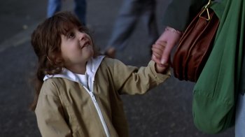 Movie still from “Searching for Bobby Fischer” (1993), directed by Steven Zaillian – A little girl is holding her mother's hand; Close Up shot, Over the shoulder angle