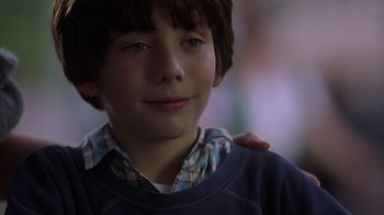 Movie still from “Searching for Bobby Fischer” (1993), directed by Steven Zaillian – A young boy with a hand on his shoulder; Close Up shot, Over the shoulder angle