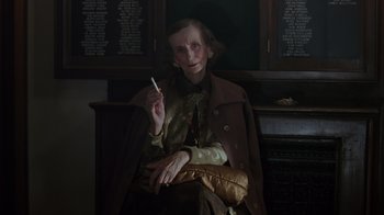 Movie still from “Searching for Bobby Fischer” (1993), directed by Steven Zaillian – An older woman sitting in a chair holding a cigarette in her hand; Close Up shot, Low angle