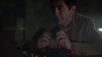 Movie still from “Searching for Bobby Fischer” (1993), directed by Steven Zaillian – A man sitting at a table with a chess set; Close Up shot, Over the shoulder angle