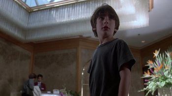 Movie still from “Searching for Bobby Fischer” (1993), directed by Steven Zaillian – A young boy standing in front of a table; Close Up shot, Low angle
