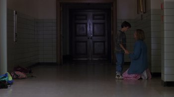 Movie still from “Searching for Bobby Fischer” (1993), directed by Steven Zaillian – A boy and a woman standing in front of a door; Wide shot, High angle