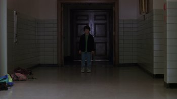 Movie still from “Searching for Bobby Fischer” (1993), directed by Steven Zaillian – A person standing in front of an open door; Wide shot, Low angle