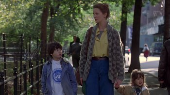 Movie still from “Searching for Bobby Fischer” (1993), directed by Steven Zaillian – A woman standing next to a young boy holding hands; Medium shot, Low angle