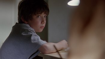 Movie still from “Searching for Bobby Fischer” (1993), directed by Steven Zaillian – A young boy sitting in front of a computer monitor; Close Up shot, Over the shoulder angle
