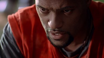A man's face in a red shirt