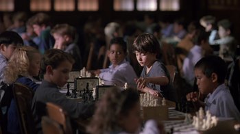 Movie still from “Searching for Bobby Fischer” (1993), directed by Steven Zaillian – A group of young people sitting around a table; Medium shot, High angle