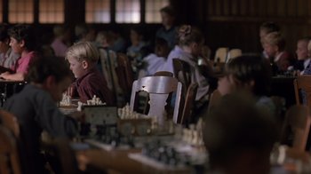 Movie still from “Searching for Bobby Fischer” (1993), directed by Steven Zaillian – A group of children sitting at a table playing chess; Medium shot, High angle