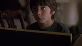Movie still from “Searching for Bobby Fischer” (1993), directed by Steven Zaillian – A young boy is looking at a computer screen; Close Up shot, High angle
