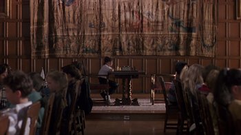 Movie still from “Searching for Bobby Fischer” (1993), directed by Steven Zaillian – A person sitting at a table in a room; Wide shot, High angle