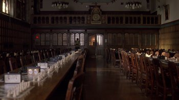 Movie still from “Searching for Bobby Fischer” (1993), directed by Steven Zaillian – A large room with a long table and many wooden chairs; Extreme Wide shot, High angle