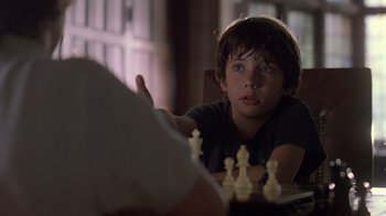 Movie still from “Searching for Bobby Fischer” (1993), directed by Steven Zaillian – A young boy sitting in front of a chess board; Close Up shot, Over the shoulder angle