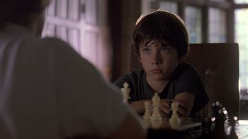 Movie still from “Searching for Bobby Fischer” (1993), directed by Steven Zaillian – A boy sitting at a table playing chess; Close Up shot, Over the shoulder angle