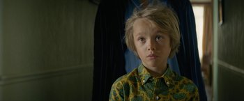 Movie still from “Seberg” (2019), directed by Benedict Andrews – A young boy wearing a yellow and green shirt; Close Up shot, High angle