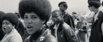 Movie still from “Seberg” (2019), directed by Benedict Andrews – A black and white photo of a group of young men; Close Up shot, Low angle