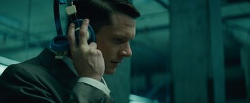 Movie still from “Seberg” (2019), directed by Benedict Andrews – A person wearing a suit and tie; Close Up shot, Low angle