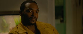 Movie still from “Seberg” (2019), directed by Benedict Andrews – A person wearing a yellow shirt; Close Up shot, Over the shoulder angle