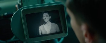 Movie still from “Seberg” (2019), directed by Benedict Andrews – A picture of a woman in a sweater is seen on a video camera; Close Up shot, Over the shoulder angle